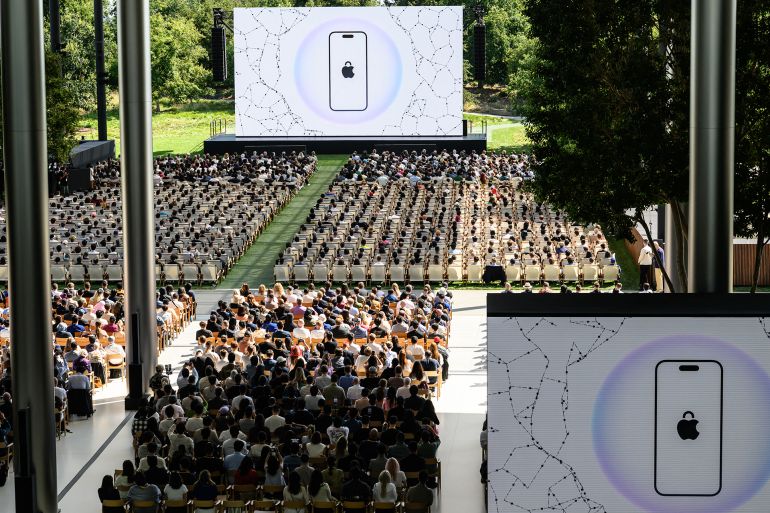 Attendees watch a presentation during the annual Apple "Worldwide Developers Conference" (WWDC) at Apple Park, the corporate headquarters of Apple Inc., in Cupertino, California on June 9, 2025. Pressure is on Apple to show it hasn't lost its magic despite broken promises to ramp up iPhones with generative artificial intelligence (GenAI) as rivals race ahead with the technology. Apple will showcase plans for its coveted devices and the software powering them at its annual Worldwide Developers Conference (WWDC) kicking off Monday in Silicon Valley and running through June 13. (Photo by Josh Edelson / AFP)