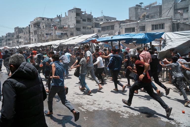 Palestinians run following an Israeli strike in Gaza City, Sunday, June 1, 2025. (AP Photo/Jehad Alshrafi)