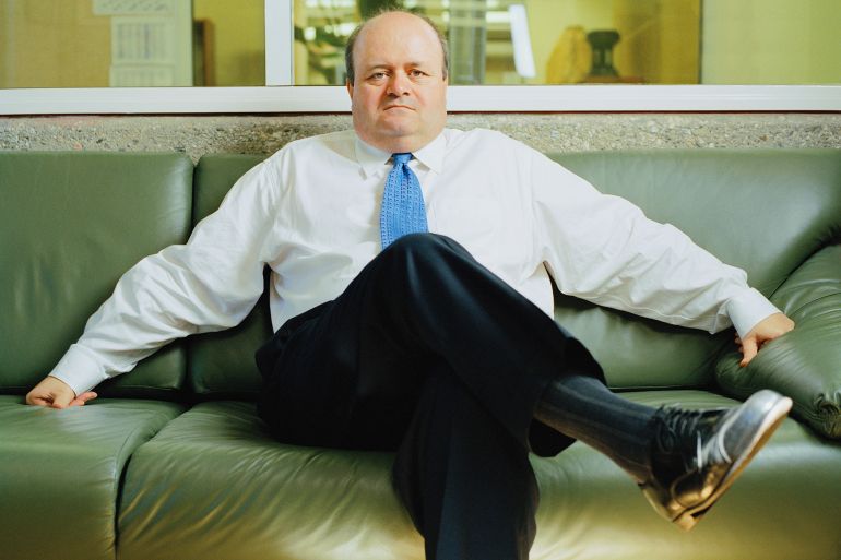 Mature businessman sitting on leather sofa, portrait - stock photo