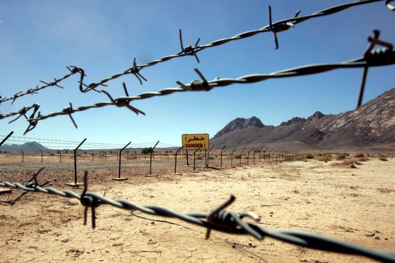 A "danger" sign and barbed wire are seen at a French nuclear test site in In-Ekker, near Ain Meguel, 170 km (106 miles) from the southern Algerian town of Tamanrasset February 16, 2007. France should apologise for atom bomb tests in its former colony Algeria which were an atrocious crime that harmed humans and the environment, an Algerian official said on Tuesday. Picture taken February 16, 2007. REUTERS/Zohra Bensemra (ALGERIA)