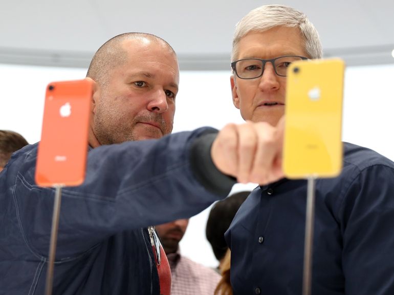 CUPERTINO, CA - SEPTEMBER 12: Apple chief design officer Jony Ive (L) and Apple CEO Tim Cook inspect the new iPhone XR during an Apple special event at the Steve Jobs Theatre on September 12, 2018 in Cupertino, California. Apple released three new versions of the iPhone and an update Apple Watch. Justin Sullivan/Getty Images/AFP== FOR NEWSPAPERS, INTERNET, TELCOS & TELEVISION USE ONLY ==