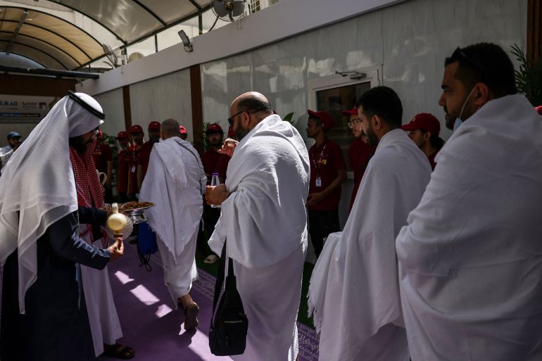 Muslim worshippers are offered tea as they arrive at a camp housing pilgrims in Mina near Islam's holy city of Mecca on June 3, 2025, ahead of the annual Hajj pilgrimage.