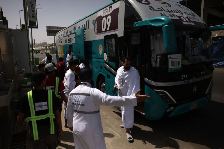 Muslim pilgrims disembark a bus in Mina near Islam's holy city of Mecca on June 3, 2025, ahead of the annual Hajj pilgrimage.