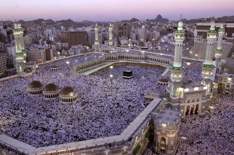 FILE- In this Monday, Feb. 18, 2002 file photo, thousands of Muslims gather around the holy Kabaa during evening prayer in the holy city of Mecca in Saudi Arabia. As Muslims from around the world stream into Mecca for the annual hajj pilgrimage this week, they come to a city undergoing the biggest transformation in its history. (AP Photo/Hasan Sarbakhshian, File)