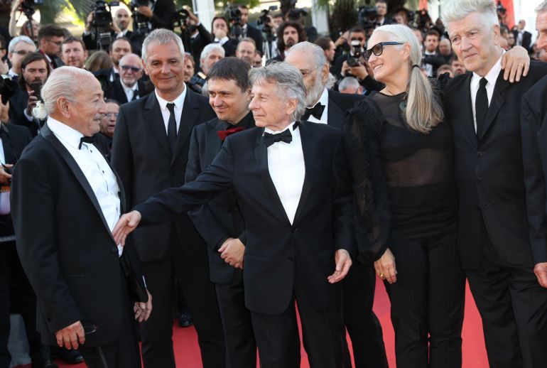 Previous former Palme d'or winners from left, Mohammed Lakhdar-Hamina, Laurent Cantet, Cristian Mungiu, Roman Polanski, Jane Campion and David Lynch pose for photographers upon arrival at the 70th anniversary of the film festival, Cannes, southern France, Tuesday, May 23, 2017. (AP Photo/Alastair Grant)