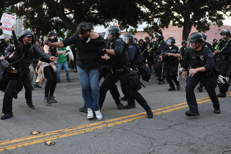 epa12167406 Police detain a protester during a protest against recent ICE raids in Los Angeles, California, USA, 09 June 2025. US President Donald Trump has deployed 2,000 National Guard troops, despite not receiving a request from the state of California for any additional assistance, following large protests against ongoing immigration enforcement raids in the Los Angeles area over the last couple of days. EPA-EFE/ALLISON DINNER