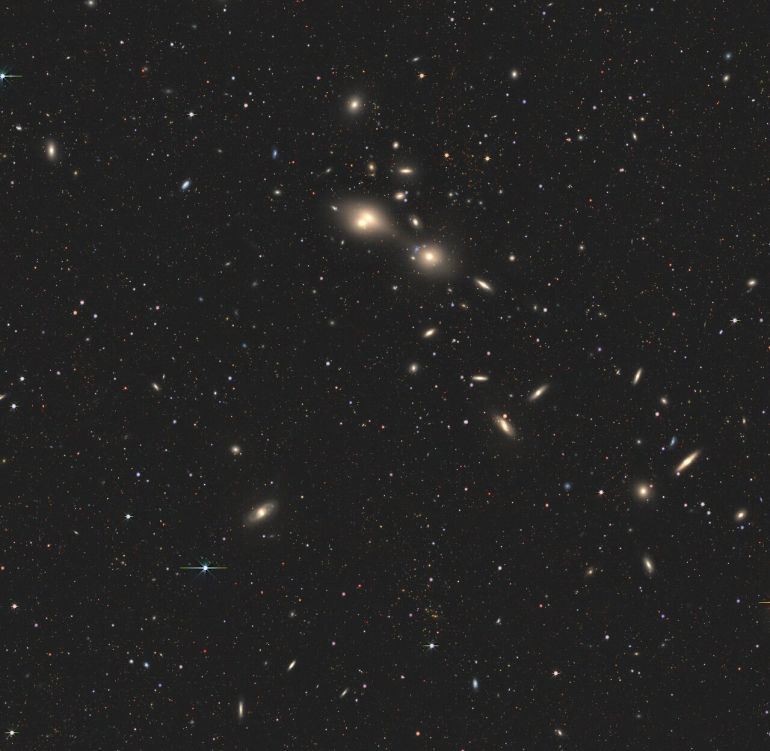 This wide-field view shows the region of the sky around a pair of interacting galaxies, nicknamed the 'cosmic joust', in which one of them is piercing the other with intense radiation. The galaxies appear as a tiny white dot at the centre of this image. The Atacama Large Millimeter/submillimeter Array (ALMA) resolved them in great detail, and ESO’s Very Large Telescope (VLT) studied the damage that one galaxy is inflicting on the other.