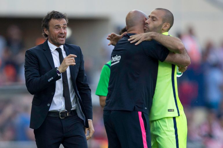 MADRID, SPAIN - MAY 17: Javier Alejandro Mascherano (R) of FC Barcelona celebrates Lionel Messi,s opening goal with a member of the team,s staff and colse to his head coach Luis Enrique Martinez (L) during the La Liga match between Club Atletico de Madrid and FC Barcelona at Vicente Calderon Stadium on May 17, 2015 in Madrid, Spain. (Photo by Gonzalo Arroyo Moreno/Getty Images)