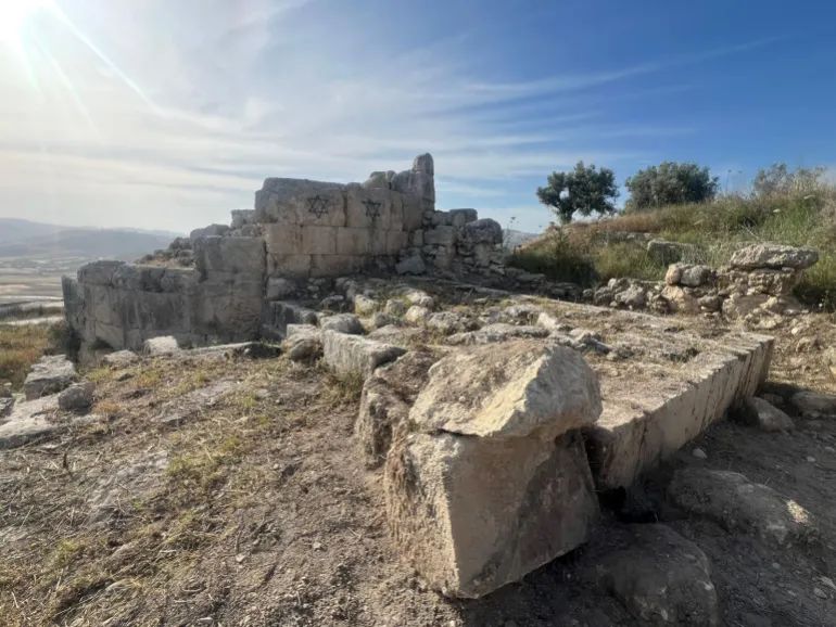 Stars of David graffitied on the ancient Hellenic wall in Sebastia [Al Jazeera]