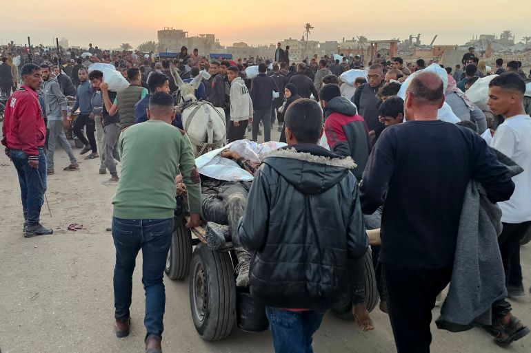 EDITORS NOTE: Graphic content / Displaced Palestinians push a cart with bodies after people were reportedly hit by Israeli fire near a food distribution centre in Rafah in the southern Gaza Strip on June 1, 2025. Gaza rescuers said Israeli gunfire killed at least 10 Palestinians and wounded more than 100 early on June 1, as thousands of people headed towards a US-backed aid distribution site. (Photo by AFP)