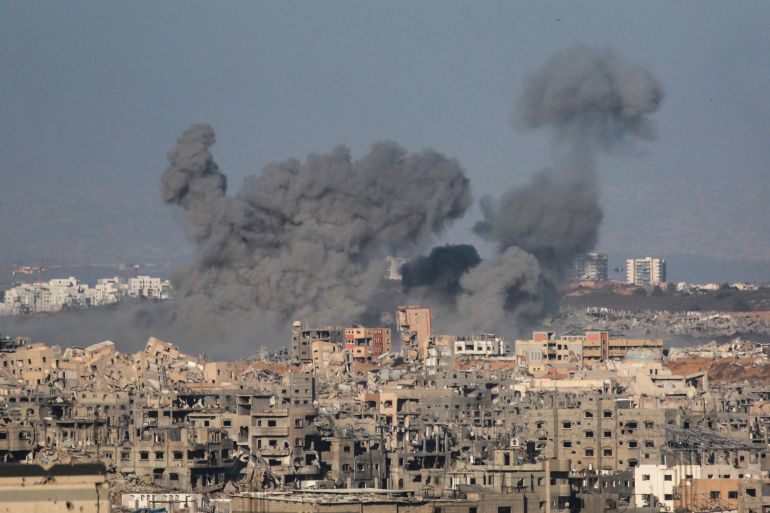 This picture taken from western Jabalia in the central Gaza Strip shows smoke billowing east of Gaza City, in the central Gaza Strip following Israeli strikes on July 13, 2025.