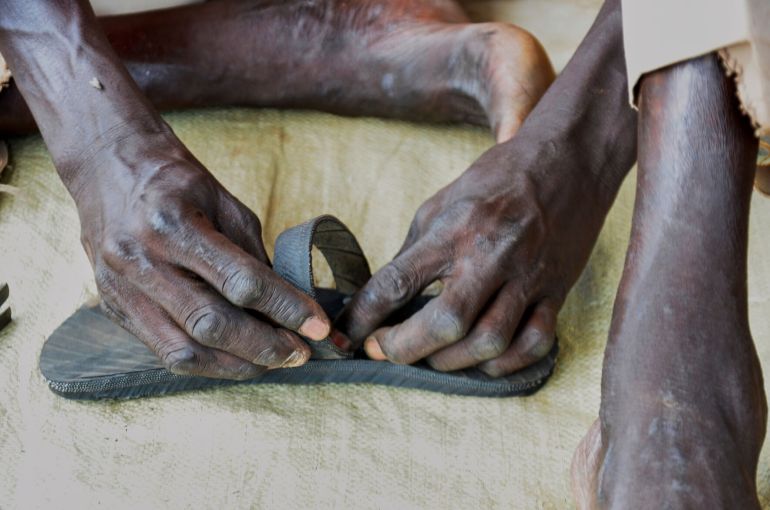 Shoemaker Emmanuel Achuil works on sandals in Wau, South Sudan, Friday, June 13, 2025. (AP Photo/Michael Atit)