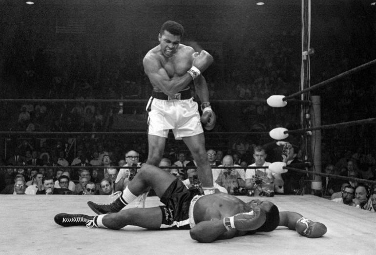 Heavyweight champion Muhammad Ali stands over fallen challenger Sonny Liston, shouting and gesturing shortly after dropping Liston with a short hard right to the jaw on May 25, 1965, in Lewiston, Maine. The bout lasted only one minute into the first round. Ali is the only man ever to win the world heavyweight boxing championship three times. He also won a gold medal in the light-heavyweight division at the 1960 Summer Olympic Games in Rome as a member of the U.S. Olympic boxing team. In 1964 he dropped the name Cassius Clay and adopted the Muslim name Muhammad Ali. (AP Photo/John Rooney)
