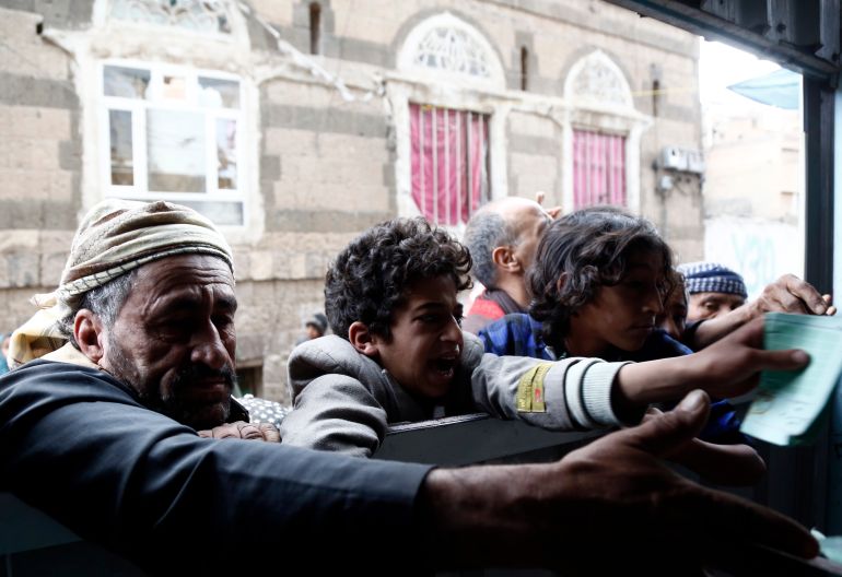 SANA'A, YEMEN - MARCH 26: People impacted by the war receive food from a local charity center on March 26, 2024 in Sana'a, Yemen. After nine years of conflict in the country, more than 18 million people are in urgent need of humanitarian assistance to survive. Almost 83 percent of the population live in poverty and hunger. (Photo by Mohammed Hamoud/Getty Images)