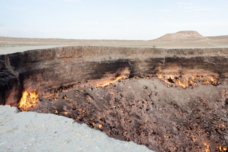 The "Door to Hell" or Darvaza Crater is a natural gas field in Turkmenistan, in the middle of the Karakum Desert. The ground collapsed into an underground cavern in 1971, becoming a natural gas crater. The diameter of the crater is 69 metres (226 ft), and its depth is 30 metres. The view of the flame burning in the desert is bewitching and intriguing.