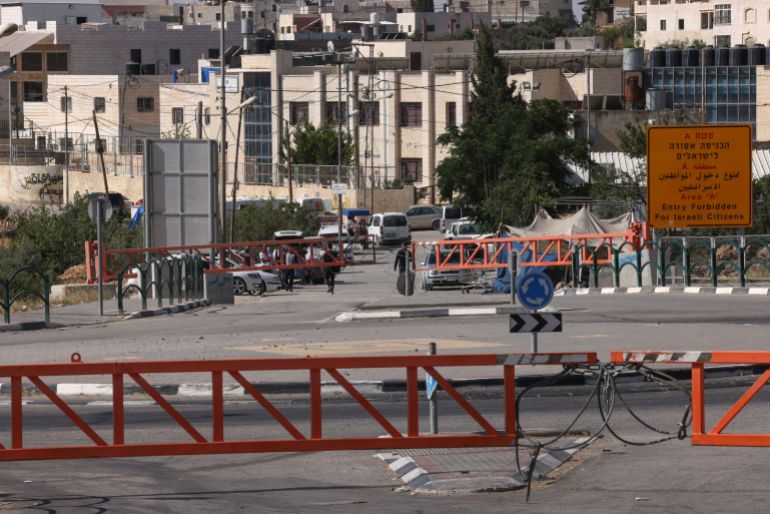 A picture shows closed iron gates set up by Israeli forces after Israeli authorities closed off all entrance and exist roads of Hebron city in the occupied West Bank on June 14, 2025. (Photo by HAZEM BADER / AFP)