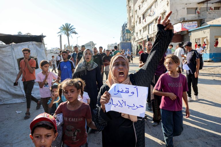 TOPSHOT - Demonstrators and journalists march in a protest against hunger in the Rimal district of Gaza City on July 19, 2025.