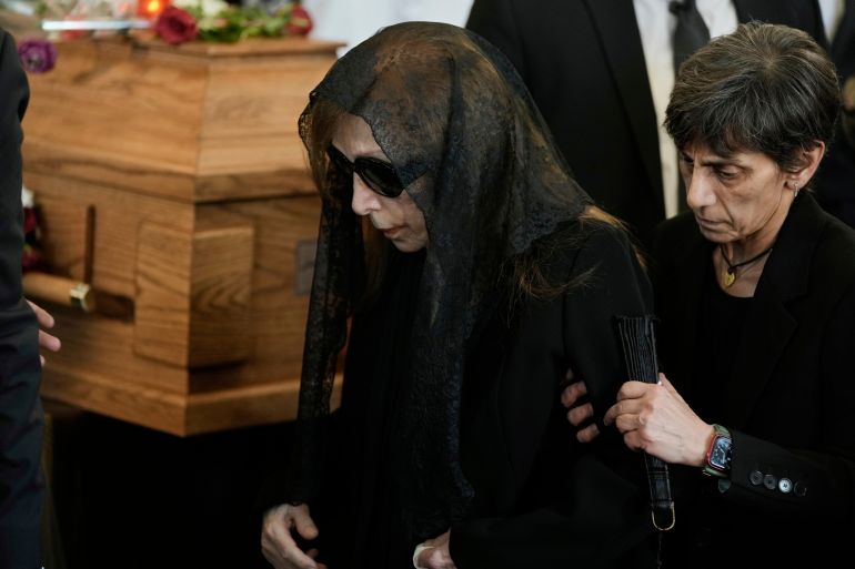 Lebanon's diva Fairuz, left, one of the Arab world's most popular singers and the mother of Ziad Rahbani, a visionary Lebanese composer, playwright, pianist and political provocateur, who died last Saturday at age 69, walks beside her son's coffin during his funeral at a church in Bekfaya town, mount Lebanon, Monday, July 28, 2025. (AP Photo/Bilal Hussein)
