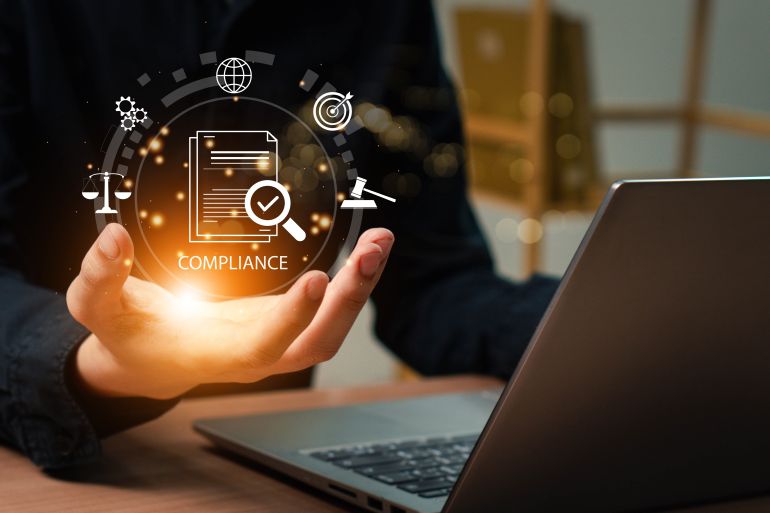 Compliance in business concept. Laws concept. Enforce laws, regulations and standards, comply with business policies, Businessman use laptop with compliance icon on virtual screen.; Shutterstock ID 2512013997; purchase_order: aljazeera ; job: ; client: ; other: