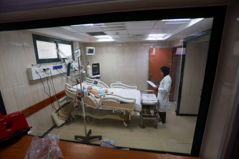Palestinian boy Siraj Al-Nouri, who was wounded in the July 10 Israeli strike the killed his two brothers, Omar and Amir, while they were queuing for supplements near a medical center, lies on a bed receiving treatment at Al-Aqsa Martyrs Hospital in Deir al-Balah, in the central Gaza Strip, July 14, 2025. REUTERS/Ramadan Abed