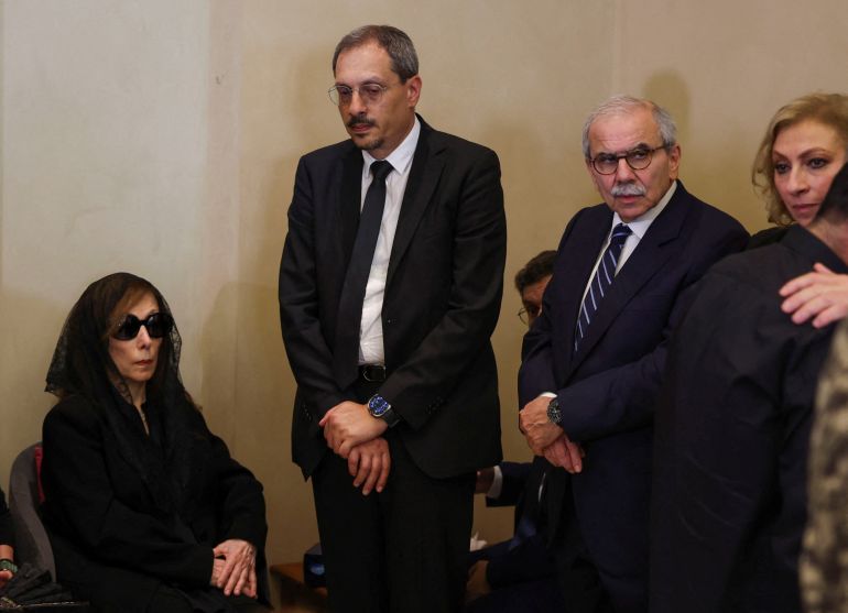 Lebanese Prime Minister Nawaf Salam pays his condolences as he stands next to Fairuz, widely seen as one of the Arab world's greatest singers, as she sits inside a church during the funeral of her son, Ziad Rahbani, the Lebanese composer and musician who passed away on Saturday, in Bikfaya, Lebanon July 28, 2025. REUTERS/Mohamed Azakir