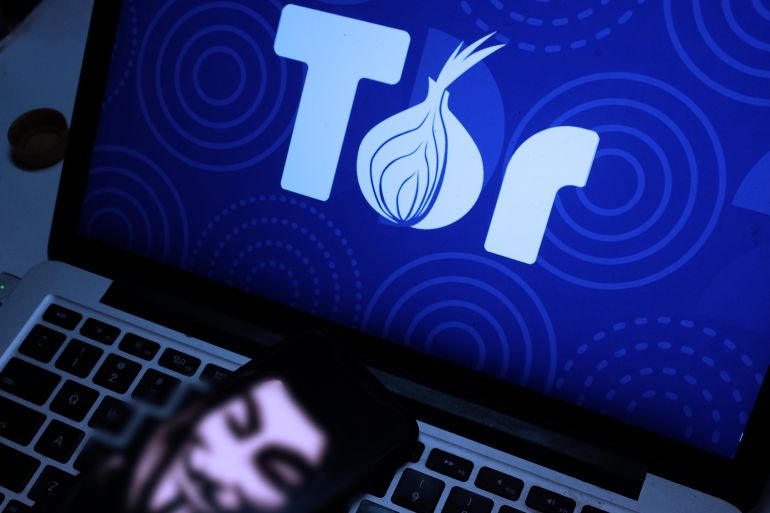 Smart phone and computer with the tor logo. Tor is the acronym for The Onion Router. An encrypted web browser. United States, New York, Friday, October 18, 2019