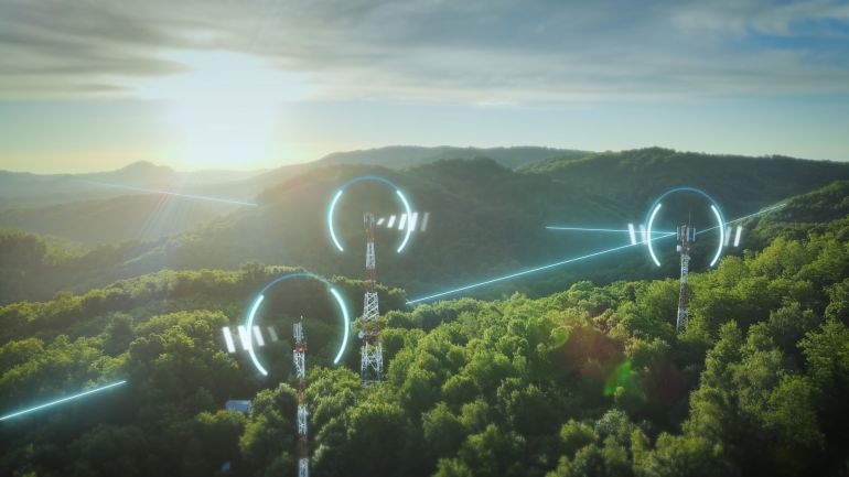 5G Telecommunication towers exchange network data through glowing digital lines