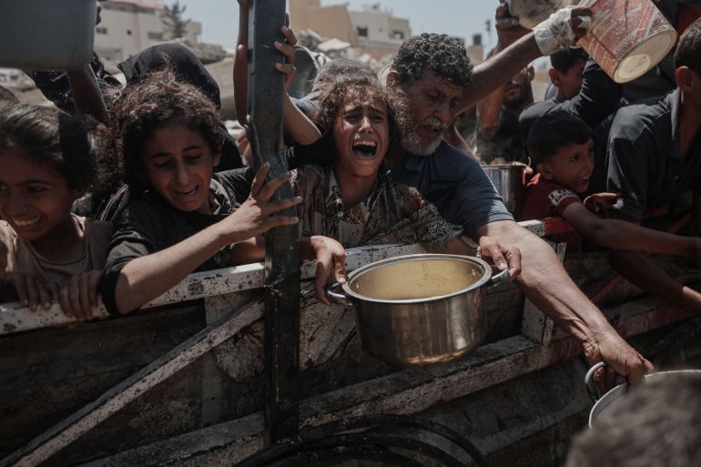 GAZA CITY, GAZA - AUGUST 2: Crowds form as Palestinians, including children, line up in Gaza City, Gaza to receive food distributed by a charity amid ongoing Israeli blockade and attacks on Gaza on August 2, 2025. ( Abdalhkem Abu Riash - Anadolu Agency )