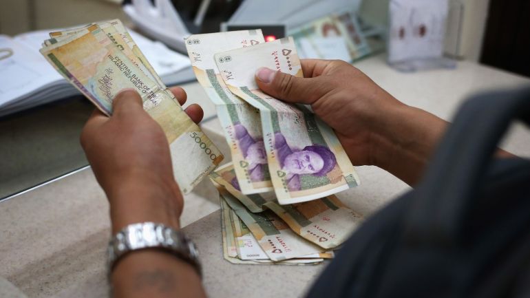 ISFAHAN, IRAN - JUNE 02: People change foreign currency for Iranian Rials at an exchange shop in the new Isfahan City Center shopping mall on June 2, 2014 in Isfahan, Iran. The mall, still under construction, is the largest shopping center in Iran and will include a 5-star hotel, a financial center and an entertainment center with cinema and fair complex. The mall is being built by Prestige Land Iran and was designed by architect Madardo Cadiz of Cadiz International. Historic Isfahan, with it's immense mosques, picturesque bridges and ancient historic bazaar, is a virtual living museum of Iranian traditional culture. It's also the Iran's top tourist destination for both Iranian and domestic visitors. On June 4 Iran marks the 25th anniversary of the death of the Ayatollah Khomeini and his legacy of the Islamic Revolution. (Photo by John Moore/Getty Images)