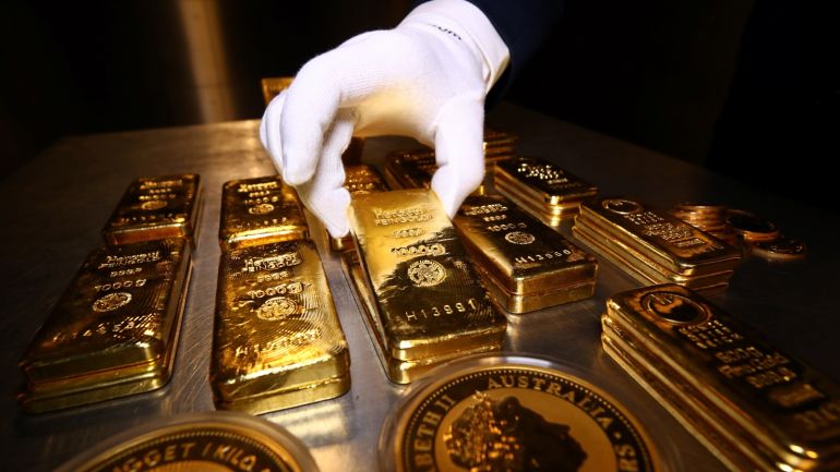 Gold bars and coins are stacked in the safe deposit boxes room of the Pro Aurum gold house in Munich, Germany, August 14, 2019. REUTERS/Michael Dalder