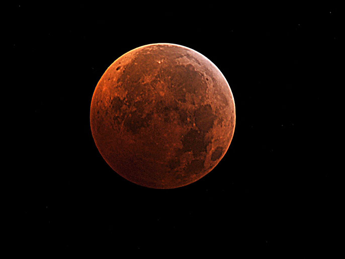 (FILES)This file photo taken in Manassas, Virginia shows the moon during the peak of a total eclipse on December, 21, 2010. Two spacecraft orbiting the moon are ending their mission by crashing into a lunar mountain at almost 4,000mph (6,437kph). The twin Gravity Recovery and Interior Laboratory (Grail) probes, known as Ebb and Flow, have spent almost a year mapping the moon's gravity in unprecedented detail. With their fuel running low, US space agency Nasa took the decision to stage a "controlled descent and impact". The alternative would have been to let the probes crash randomly which may have damaged places of historic interest, such as the Apollo landing sites. The spacecraft will be flown into a mountain on the edge of a crater near the moon's north pole. There will be no spectacular images of the impact because the region will be in shadow. AFP PHOTO / KAREN BLEIER / FILES