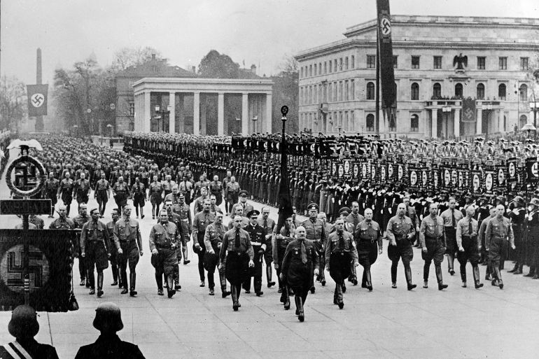 Leading members of the Nazi party march along Koenigliche Platz in a parade in 1938. In the background is Hitler's Munich palace. Nazi officials that can be identified include Hermann Goering (third man from swastika banner), Alfred Rosenberg, directly behind man in dark uniform, Grand Admiral Erich Raeder. Leading parade is Julius Streicher, governor of Franconia. Behind and left of him is Col. Gen. Wilhelm Keitel. To Keitel's left is Gen. Erhard Milch. Next to Milch is Ullrich Graf, who protected Hitler during the 1923 putsch. Heinrich Himmler, chief of secret police and Dr. Wilhelm Frick, right, are the men at the extreme right of the long front line. (AP Photo)