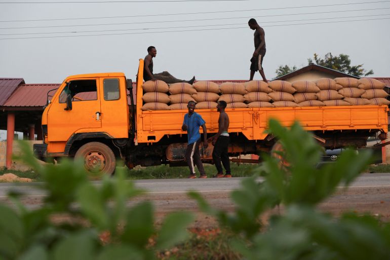 A truck transporting bags of sun-dried cocoa beans parks along the roadside in Assin Foso, Ghana, November 20, 2024. REUTERS/Francis Kokoroko