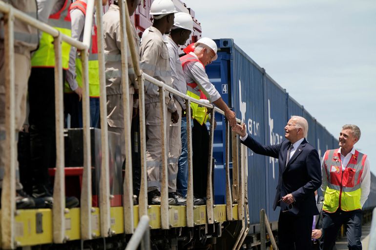 US President Joe Biden (3rd R) meets employees of Lobito Atlantic Railway (LAR) with Director of Operations (COO) at LAR Nicolas Gregoir (R) at the Port in Lobito on December 4, 2024. (Photo by ANDREW CABALLERO-REYNOLDS / AFP)