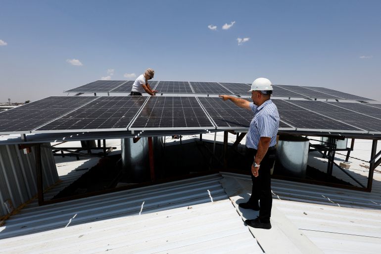Workers inspect solar panels, an increasingly popular sustainable energy option for homes and farms to generate electricity, in Mosul, Iraq, July 9, 2025. REUTERS/Khalid Al-Mousily