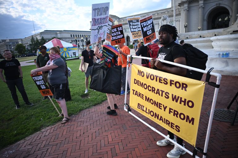 Activists rally during a "Rage Against the Regime" protest at Columbus Circle, in front of Union Station in Washington, DC on August 2, 2025.