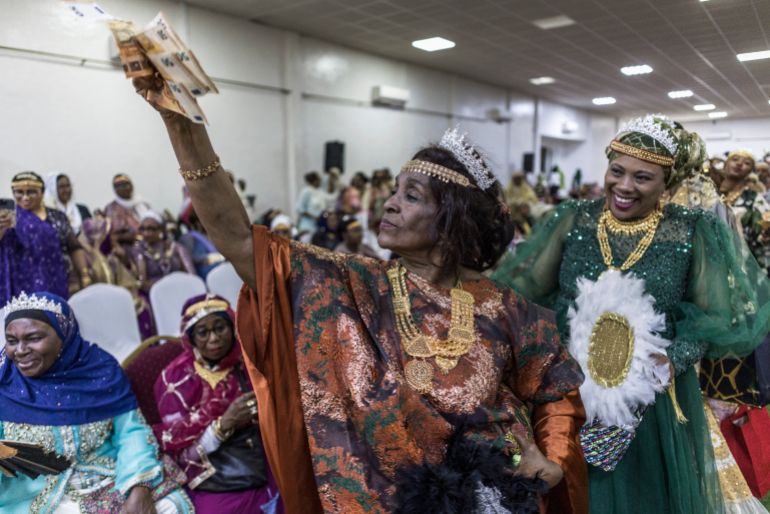 Amadi Maria (L), the mother of Franco Comoran Faid Kassime (not seen), who lives with his wife Faizat Aboubacar (not seen) in Reunion, holds 50 Euros banknotes while dancing during the Ukumbi, a women only reception marking the end of the Grand Mariage celebrations, at the Foyer des Femmes (a local venue dedicated to women only gathering) in Moroni, on July 20, 2025 during the evening reception of the couple’s Grand Mariage.