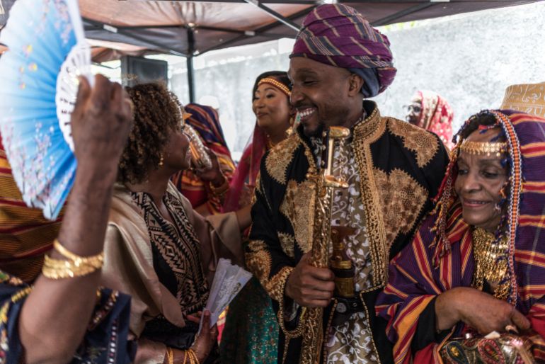 Franco Comoran Faid Kassime takes part in a dance during which the guests leave sums of money for the couple in Moroni on July 20, 2025 during the main reception for the Grand Mariage ceremony at his brideÕs Faizat Aboubacar (3rd R) family home.