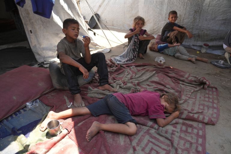 Children from the Sobh family rest inside their tent at a camp for displaced Palestinians in Gaza City, Thursday, July 24, 2025. (AP Photo/Jehad Alshrafi)