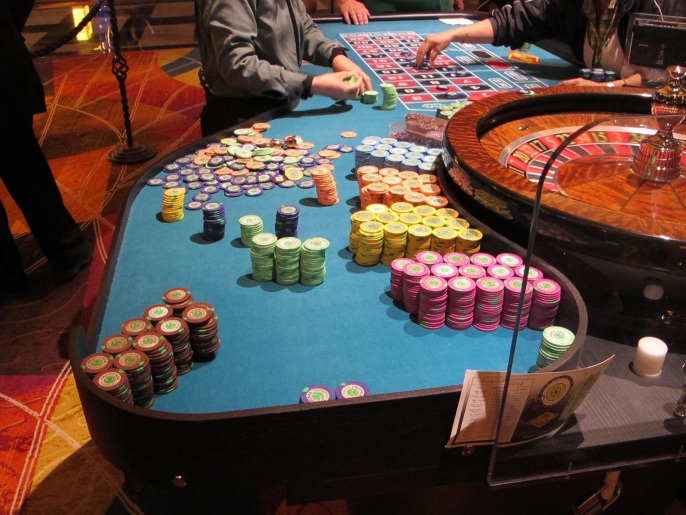 FILE - This April 17, 2015 file photo shows gambling chips next to a roulette table at the Tropicana casino in Atlantic City, N.J. A plan to let New Jersey voters decide in November whether to authorize two new casinos in the northern part of the state is moving forward in the Legislature. But key details are still missing, including the tax rate the new casinos would pay, and where they would be located. (AP Photo/Wayne Parry, File)