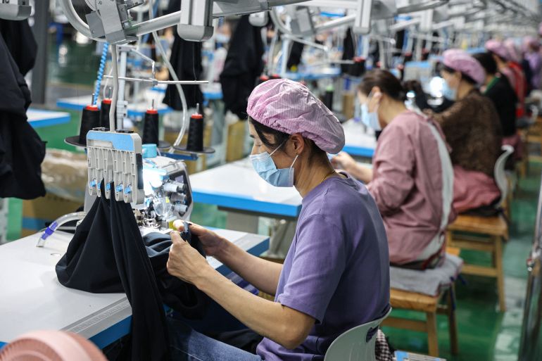 Employees work on a T-shirt production line at a clothing factory in Binzhou, in eastern China's Shandong province on April 22, 2025. (Photo by AFP) / China OUT / CHINA OUT / CHINA OUT