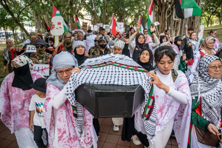 epa12279606 Protesters carry a mock coffin during a rally titled 'March for Gaza' in Kuala Lumpur, Malaysia, 02 August 2025. More than a thousand people joined the peaceful demonstration, part of a global movement calling on Israel to immediately end the use of starvation as a weapon of war. EPA/NAZIR SUFARI