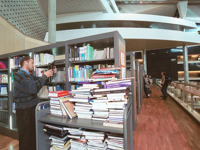 400775 04: Library staff fill shelves with books inside the newly completed Alexandria Library at the University of Alexandria February 7, 2002 in Egypt. The Bibliotheca Alexandrina will officially open April 23, 2002, restoring the library founded by Ptolemy II in 295 B.C. to its past glory when it was the intellcutal hub of Hellenistic culture from 400 B.C.to 300 A.D. The library will be able to handle 4 million books on the shelves and another 4 million in storage.