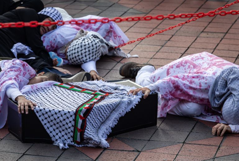 KUALA LUMPUR, MALAYSIA – AUGUST 02: Pro-Palestinian protesters perform an act highlighting the ongoing crisis in Gaza during a march to express solidarity with the people of Palestine on August 2, 2025in Kuala Lumpur, Malaysia. Protesters in Malaysia joined marches and actions globally, as pressure mounts on the Israeli government over a devastating humanitarian crisis unfolding as its war against Hamas continues. (Photo by Annice Lyn/Getty Images)
