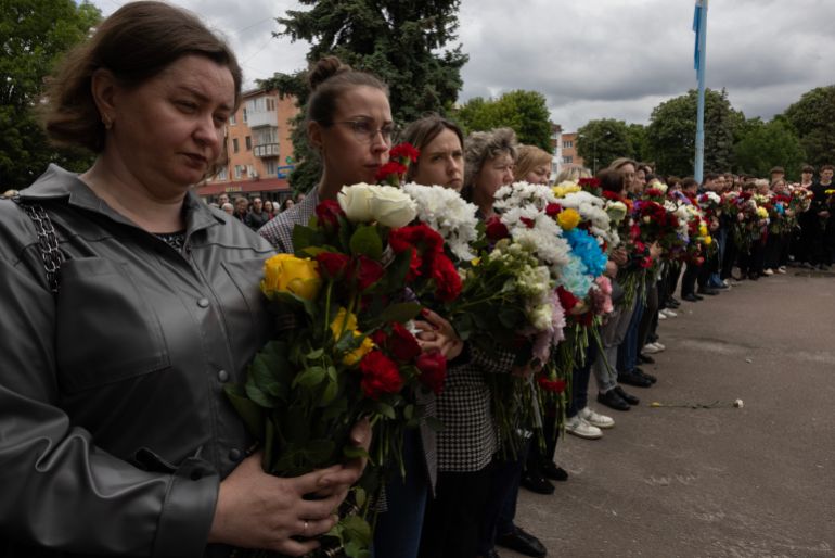 ZHYTOMYR, UKRAINE - MAY 28: Mourners attend a funeral for the three children from the Martyniuk family who were killed when Russia launched a massive aerial attack on May 25th across multiple cities, on May 28, 2025 in Korostyshiv, Zhytomyr region, Ukraine. Russia fired over 367 missiles and drones across Ukraine over the weekend, causing U.S. President Donald Trump to criticize Russian President Vladimir Putin, calling him "absolutely crazy". (Photo by Paula Bronstein/Getty Images)
