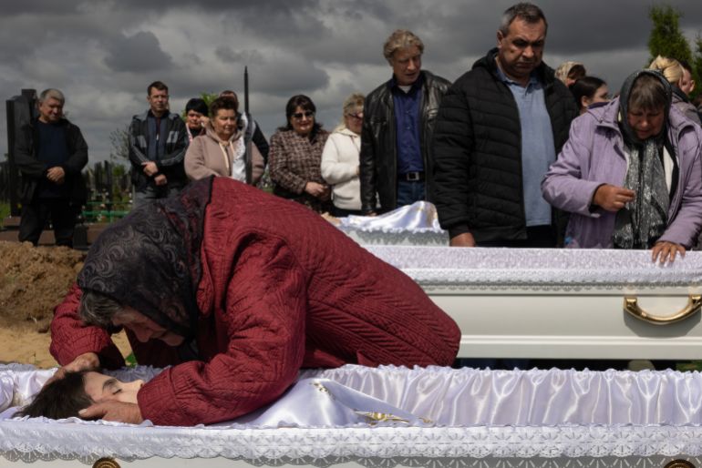 ZHYTOMYR, UKRAINE - MAY 28: (EDITOR'S NOTE: Image depicts death.) A grandmother says goodbye to her grandson, Roman Martyniuk, 17, who was killed along with his siblings Tamara and Stanislav, during a funeral for the three children who were killed when Russia launched a massive aerial attack on May 25th across multiple cities, on May 28, 2025 in Korostyshiv, Zhytomyr region, Ukraine. Russia fired over 367 missiles and drones across Ukraine over the weekend, causing U.S. President Donald Trump to criticize Russian President Vladimir Putin, calling him "absolutely crazy". (Photo by Paula Bronstein/Getty Images)