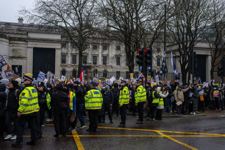 LONDON, ENGLAND - FEBRUARY 8: Protesters scuffle with police officers during a demonstration at the proposed site of China's embassy on February 8, 2025 in London, England. Protest groups from various diasporas, including Hong Kong, Tibet, Uyghur, Chinese dissidents, and other resident organisations, aim to demonstrate that the Royal Mint Court site is inappropriate for an embassy, as there is not enough space for safe demonstrations. (Photo by Carl Court/Getty Images)