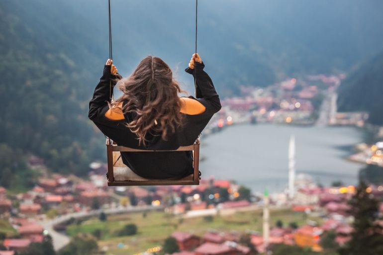 People on a swing view the view on the mountain lake Uzungol, Trabzon, Turkey. Uzungol, Turkey - October 03 2020.; Shutterstock ID 1861067095; purchase_order: ajnet; job: ; client: ; other: