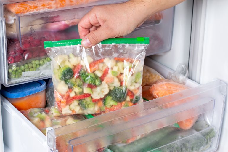 Plastic bags with different frozen vegetables in refrigerator. Food storage; Shutterstock ID 2065321247; purchase_order: aj; job: ; client: ; other:
