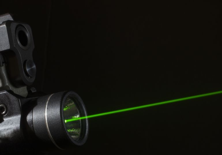 Green laser that is mounted on the bottom of a handgun
